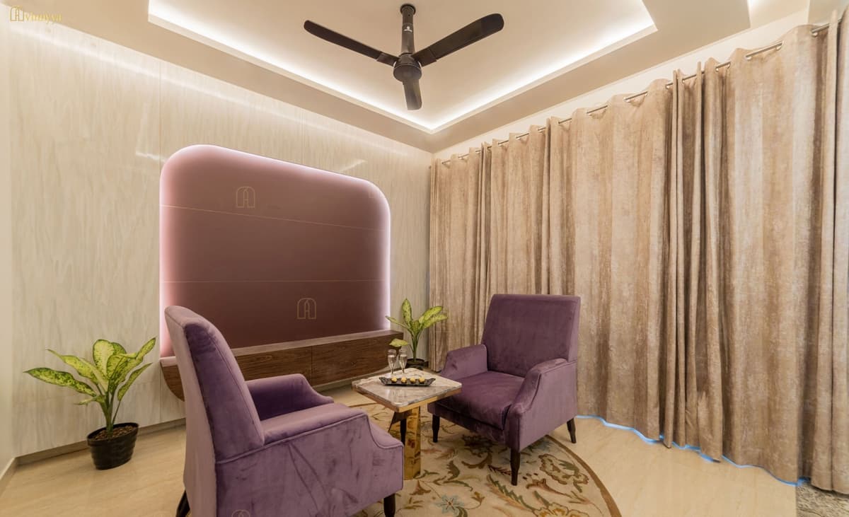 Sitting area with plum armchairs and a cove-lit ceiling — Orabella, Varanasi